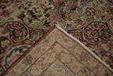 A folded corner of an antique Kerman carpet revealing its hand-knotted wool foundation.