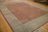 Vintage distressed Mir Sarouk corner with intricate powder blue border and worn brick red field.