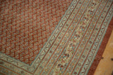 Distressed Mir Sarouk rug corner, red boteh field with faint foundation, pale blue borders.