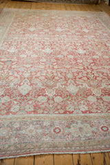 Distressed vintage Persian Mahal rug, faded ruby floral arabesques with visible texture and wear.