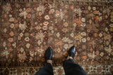 Overhead view of the time-softened texture and floral pattern on a vintage Malayer rug runner.