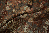 Close-up of the abrashed charcoal ground and botanical patterns on a vintage Malayer runner.