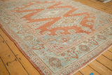 Intricate floral main border and abrashed rust-red field of a vintage Persian Veece carpet.
