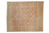 Vintage distressed Sarouk carpet with a faded allover floral pattern in ruby red, ivory, and pale blue tones.