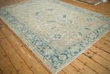 Turtle Samovar border in dusty blue on a distressed sandy ivory Persian Heriz carpet.