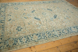 The Turtle Samovar motif in dusty aqua blue on a vintage distressed Heriz carpet's border.
