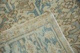 The hand-knotted foundation and distressed pile of a vintage Heriz, seen from the corner.