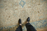 Close view of a distressed Heriz carpet showing the even wear across its hand-knotted geometric pattern.