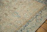 Close detail of the distressed Heriz carpet's even wear and geometric Turtle Samovar border.