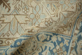 Detail of the distressed Heriz carpet's hand-knotted pile showing mostly even wear to the knot heads.