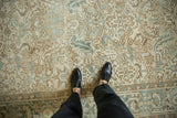 Distressed Mehrivan carpet's unique texture with geometric floral motifs and soft patina.