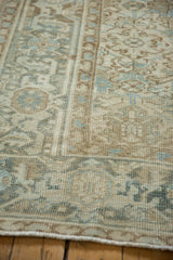 Distressed vintage Mehrivan carpet pile with worn knot heads, muted cream and blue tones.