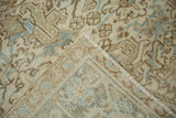 Distressed Mehrivan rug corner revealing geometric floral pattern, intact selvage, and woven back.
