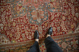 Vintage distressed Ahar carpet with intricate palmettes and floral details in red, teal, and blush.