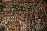 Close view of the vintage Ahar carpet's corner showing floral arabesques with mostly even wear to knot heads.