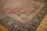 Corner view of a vintage Ahar rug with floral arabesques in its slate blue and ivory borders.