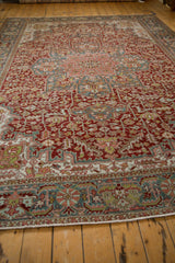 A low angle highlights the texture and intricate floral pattern of the distressed vintage Ahar carpet.