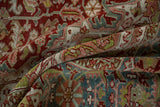 A folded view of the distressed Ahar carpet showing its textured pile and colorful floral arabesques.