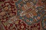 Distressed low pile of a vintage Ahar carpet showing hand-knotted details and colorful floral arabesques.