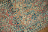 Distressed Sarouk runner showing elongated floral motifs in ruby red and dusty teal pile.
