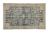 Distressed Persian Hamadan rug with faded dusty navy blue and beige geometric floral design.