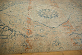 Vintage Meshed carpet with distressed texture, faded blue palmettes, and abrash.