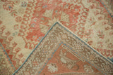 Flipped corner of a distressed Shiraz rug showing the back weave and sky blue side cord selvage.