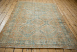 Secured side selvage and worn texture of a vintage distressed Afshar rug.
