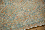 Distressed vintage Afshar rug corner with worn pile, faded blue and orange geometric patterns.