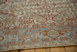 Detail of the Heriz rug's Samovar Turtle border in powder blue, red, and ivory with distressed texture.