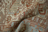 Close-up of a distressed Heriz rug's low pile texture and geometric Samovar Turtle motifs.