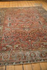 Angled view of the vintage Heriz carpet highlighting its low pile and geometric motifs.