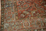 Corner of a distressed Heriz carpet with a dusty teal Turtle Samovar border design.