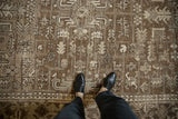 Detailed view of the Turtle Samovar motifs and distressed low-pile texture on a vintage Mehrivan carpet.