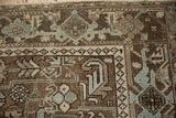 Geometric Turtle Samovar border in chocolate brown and powder blue on a distressed carpet.