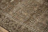 Inner seed design border and worn geometric floral patterns in beige and chocolate brown.