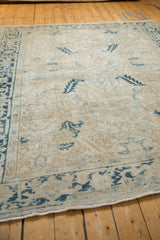 Angled view of the worn texture and blue Turtle Samovar border on a vintage Mehrivan rug.