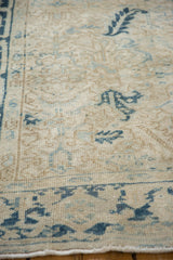 Close-up of the distressed rug's even wear, showing low pile and exposed knot heads.