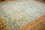 Distressed vintage Heriz carpet border, revealing geometric motifs and worn texture in dusty blue.
