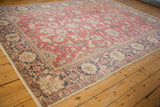 Distressed vintage Turkish Sparta carpet corner, raspberry red field and navy border.