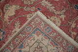 Distressed vintage Sparta carpet corner: raspberry red pile, fringe, and woven foundation.
