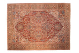 Distressed vintage Heriz carpet with a large geometric medallion in cherry red, sky blue, blush, and antique ivory.