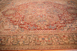Decorative time-softened texture on a Heriz carpet's pomegranate and geometric vine pattern.