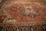 Heriz carpet corner, navy border with Herati-style Turtle Samovar motif and stepped ivory spandrel.