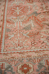 Low pile texture on a distressed Heriz carpet with stylized turtle motifs in dusty blush, slate blue, and ivory.