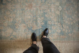 Low pile texture and even wear of a distressed Tabriz carpet in powder blue and ivory.