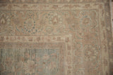 Heavy abrashes and worn texture on the floral palmettes of a vintage Persian Tabriz.