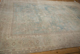 Angled view of the distressed Tabriz carpet showing the even wear and textural low pile.