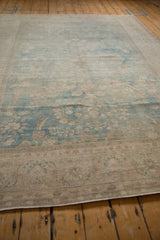 Low angle view of a distressed Tabriz carpet, highlighting its worn pile and color abrashes.