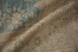 Angled close-up of a vintage Tabriz rug's low pile and time-softened ribbed texture.